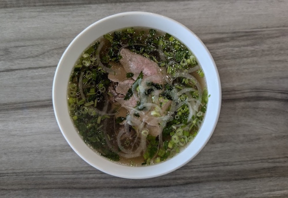 Steaming bowl of phở tái